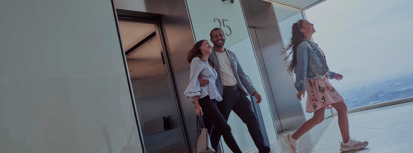 People smiling while exiting an elevator